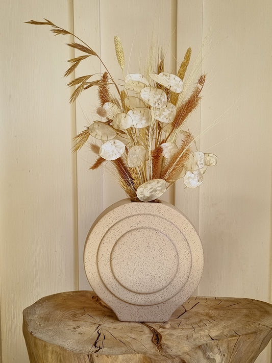 Disc vase with wild grass bouquet