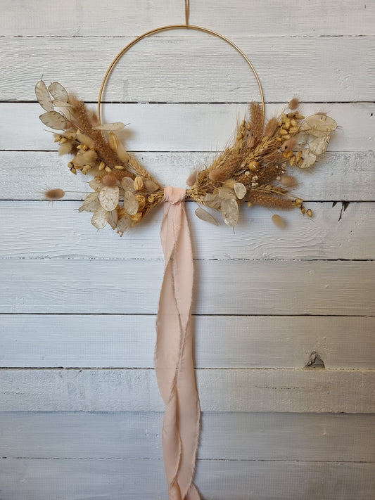 Long view blush winged wreath with ribbon
